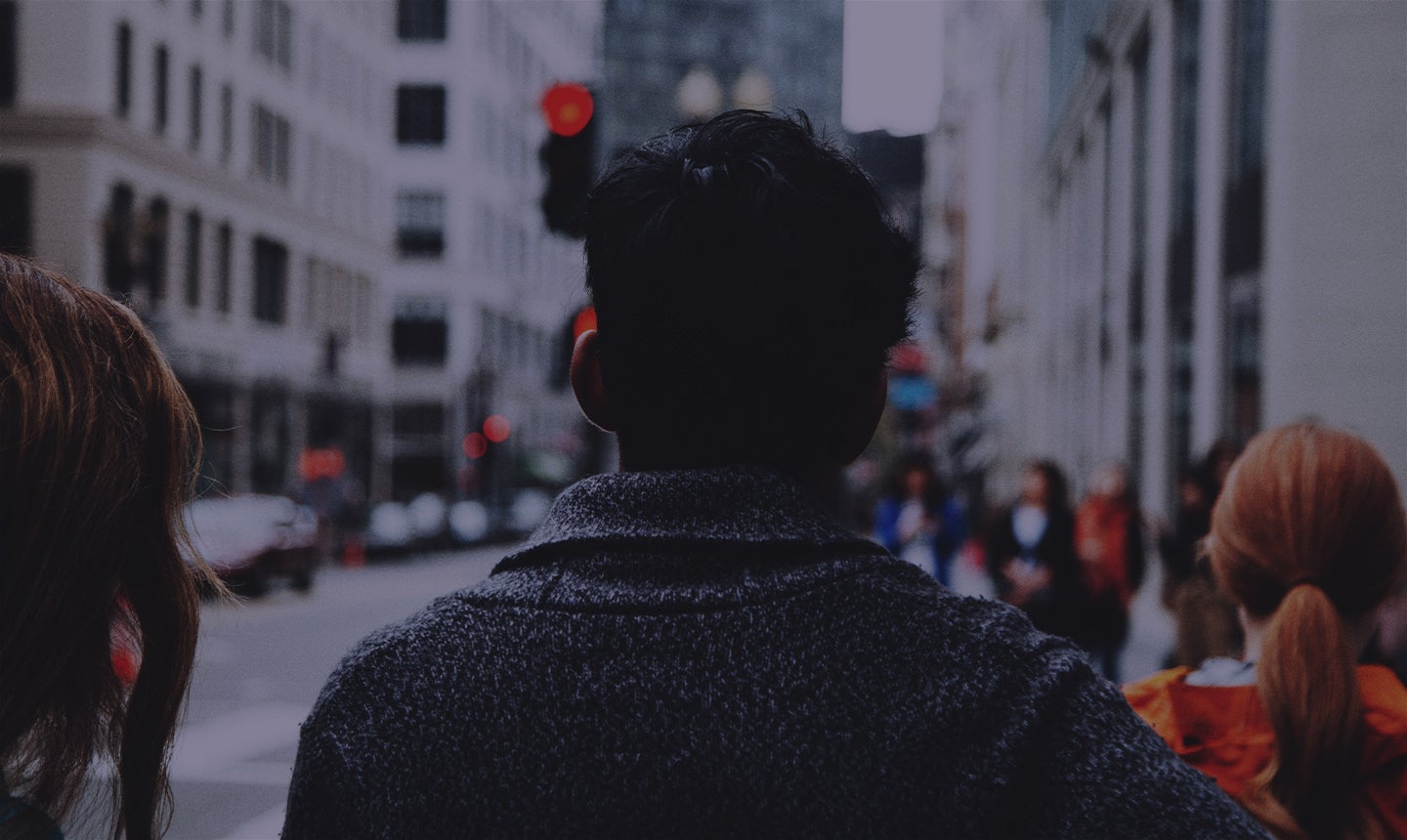 Person walking down a crowded city sidewalk.