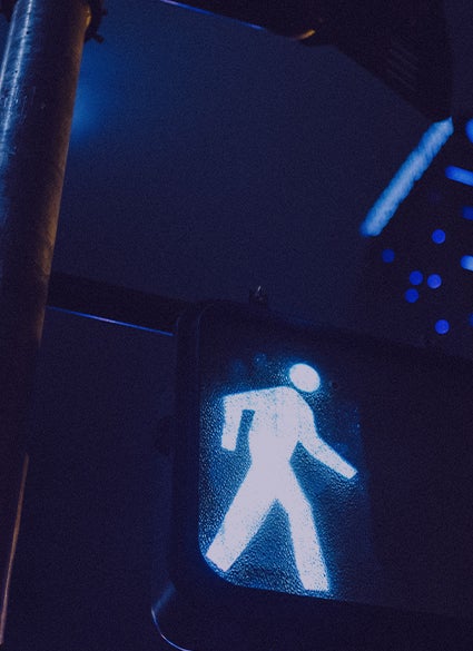 Light up walk sign at a crosswalk.