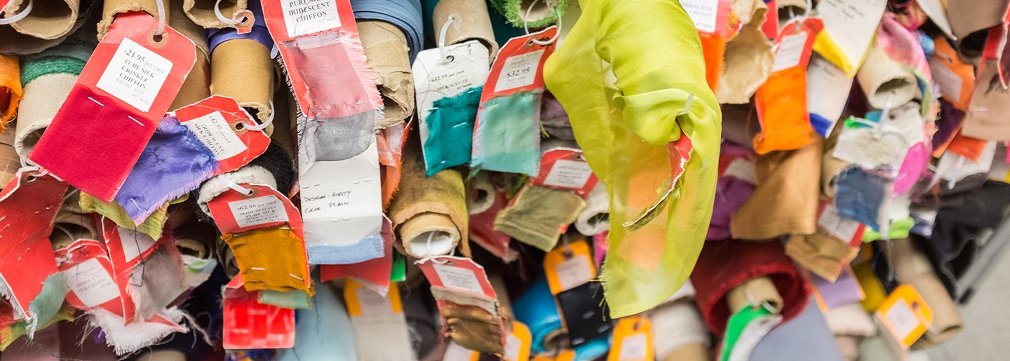 Stacked rolls of colorful fabric.