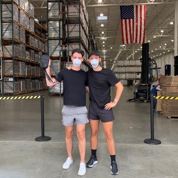 Anthony and Baylen holding the PPE product they developed.