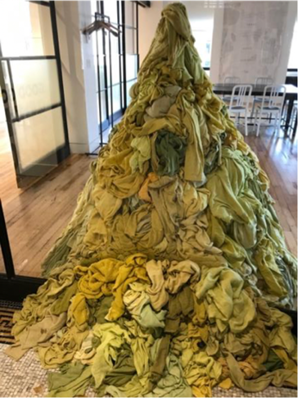 Eileen Fisher work of art, a green pile of clothing in a tree pattern