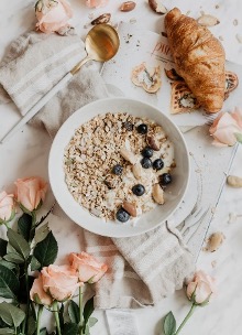 Breakfast of Oatmeal with blueberries and a croissant