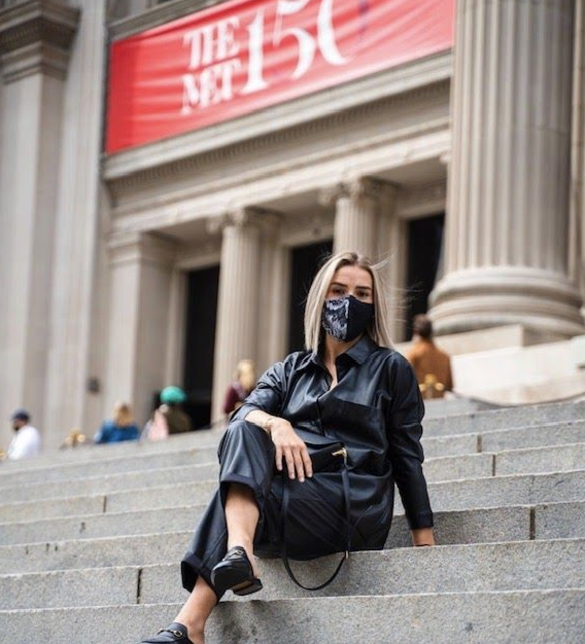 Girl in Mask sitting on the steps at the Met
