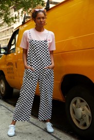 Fashion Lab model standing next to moving van on street