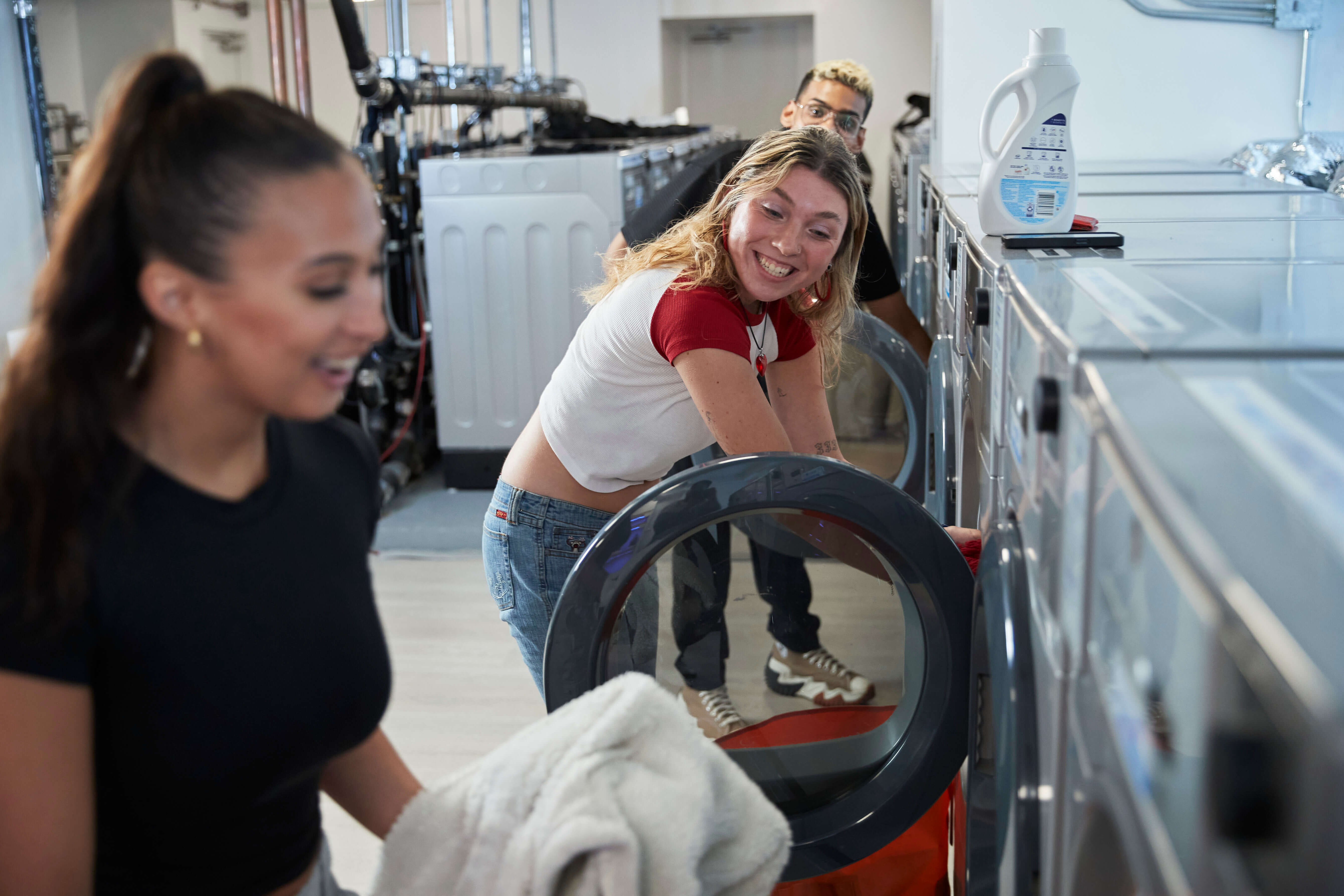 People doing laundry in FOUND Study laundry room