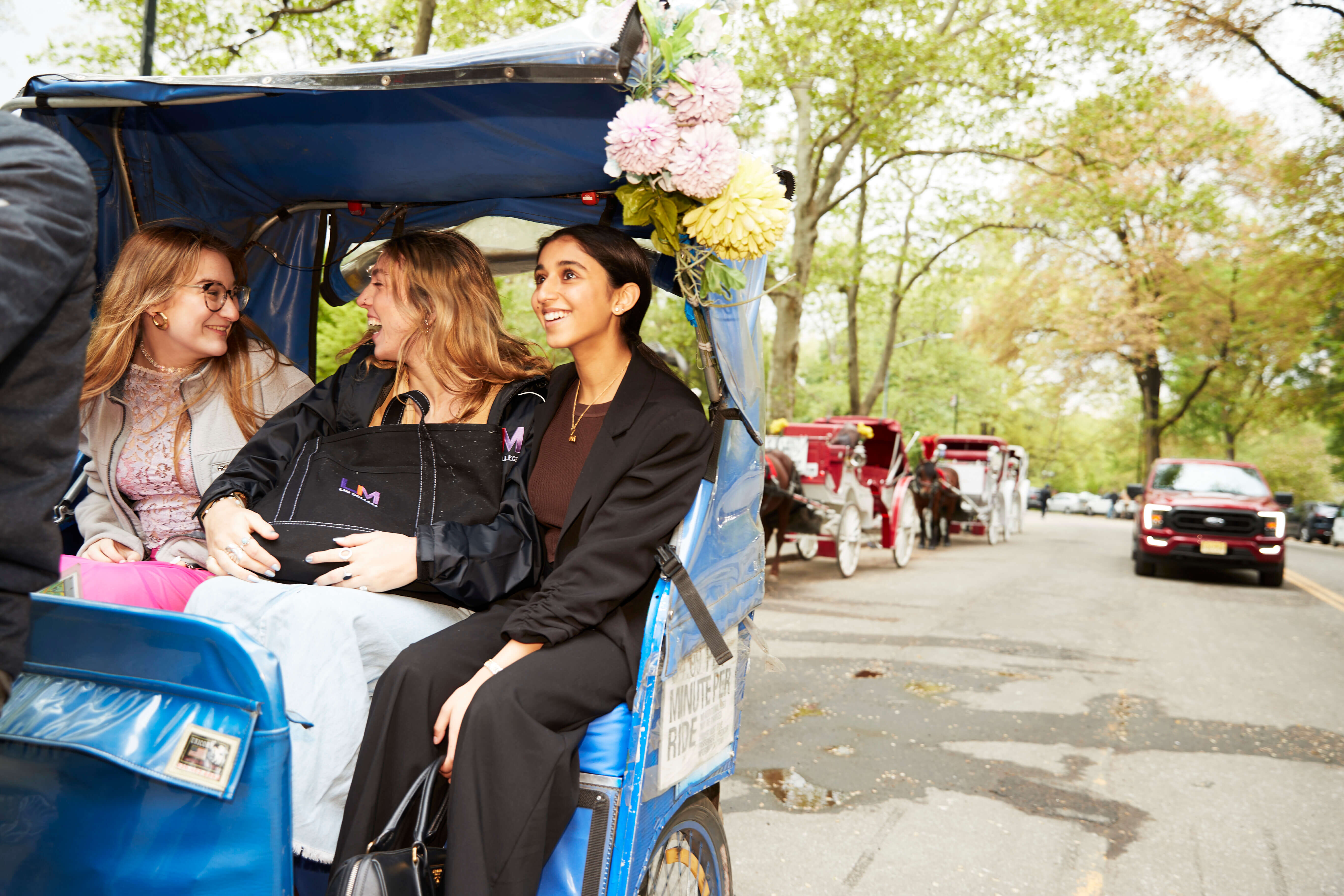 three female students in a carriage ride in Central Park