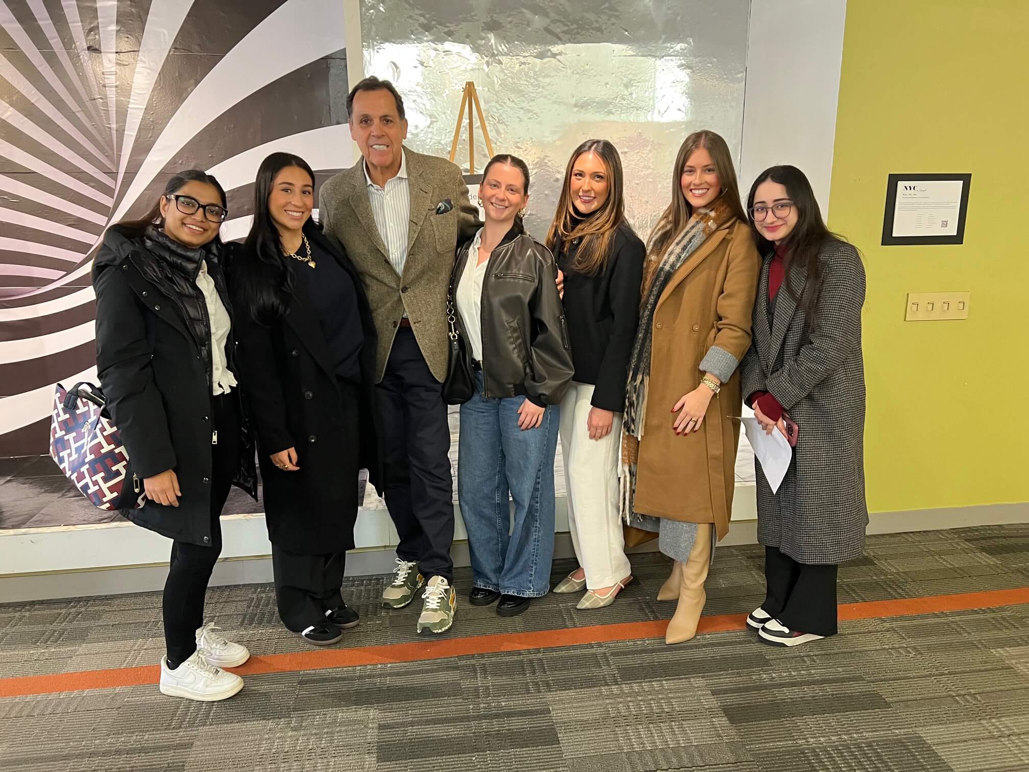 Sam Edelman with students on LIM's campus