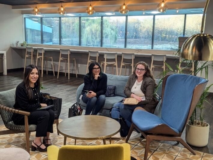 group of women, business casual attire, mixed tile and wooden floor, comfortable chairs