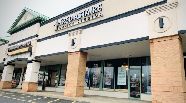 Fred Astaire Dance Studio exterior, outdoor mall-front, bring stanchions, class storefront doors and windows