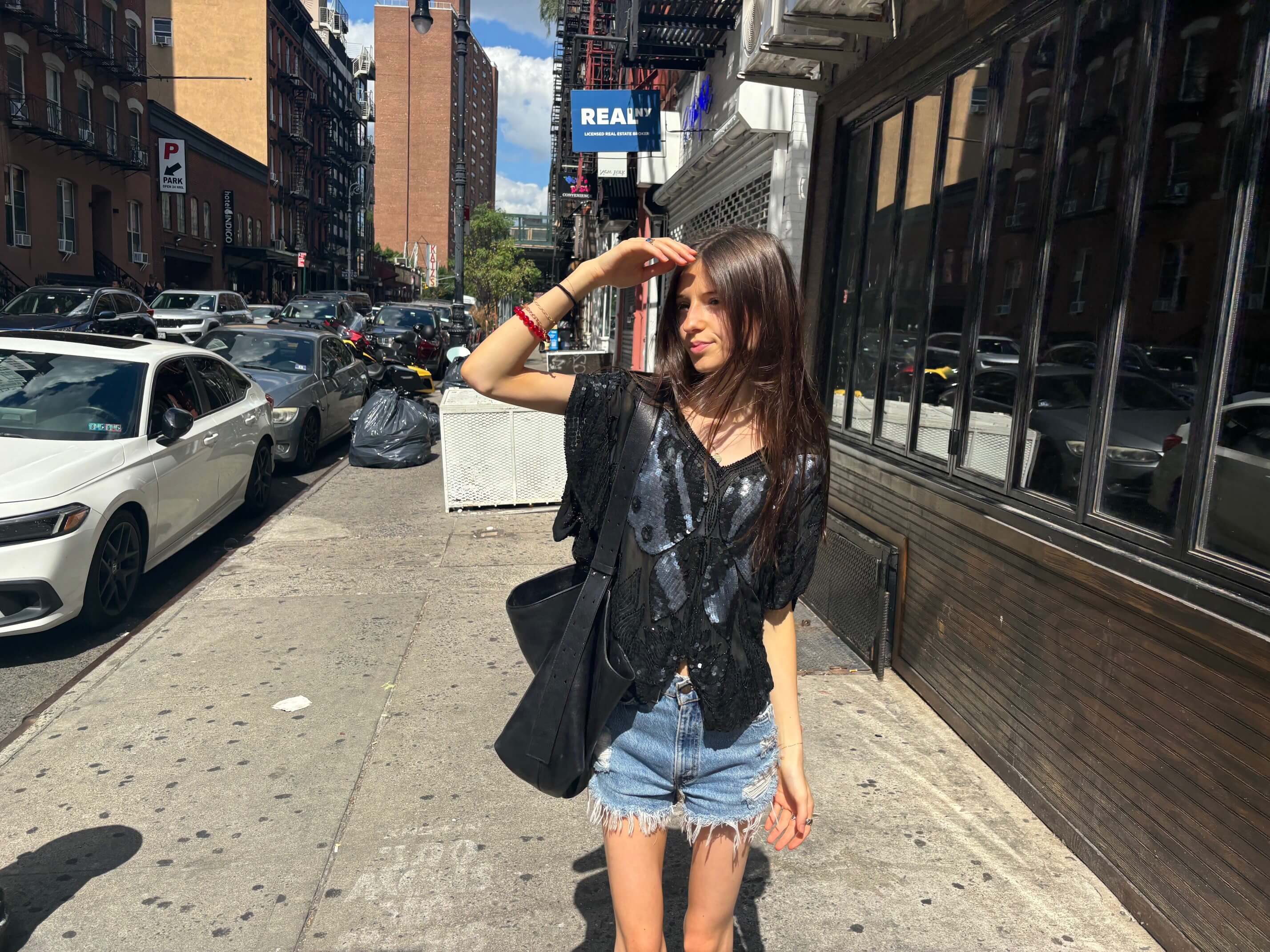 young woman, leather top, jean cutoffs, NYC street