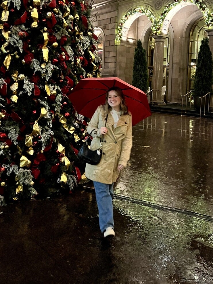 Molly outside Lotte New York Palace, rain