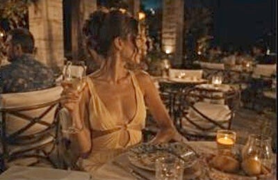 young woman, white summer-attire blouse, wine class, restaurant setting