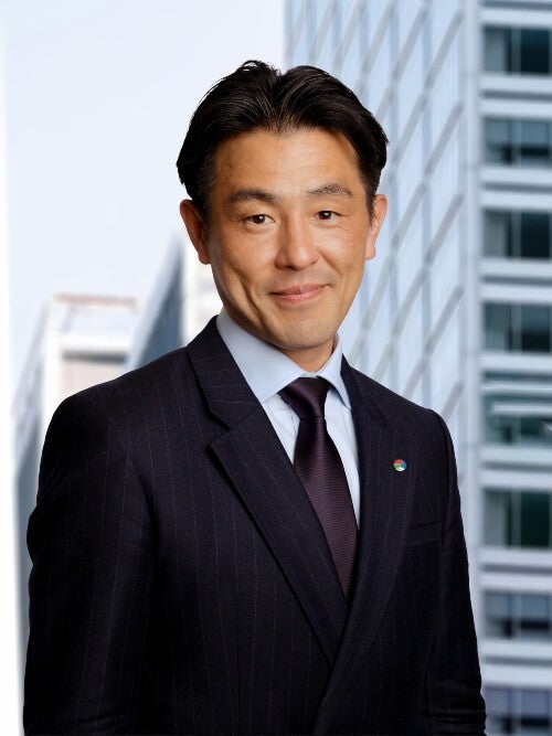 professionally dressed man, dark hair, professional headshot, dark tie, pinstriped suit
