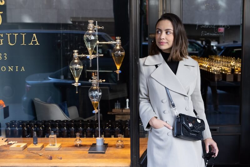 Student standing in front of luxury storefront