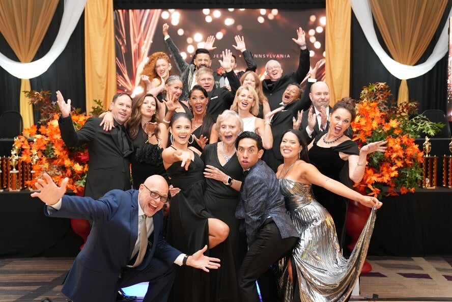 Group of dancers at Fred Astaire Dance Studio in Marlboro, NJ, all glamorously dressed