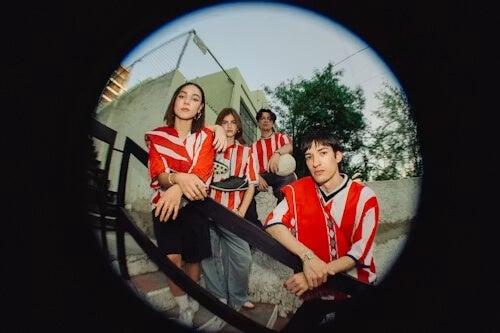 stylized fish-eye lens photo of a group of young people wearing white and red athleticwear