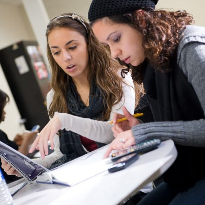 Two LIM College students working on an assignment