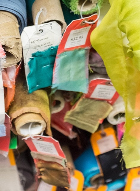 Stacked rolls of colorful fabric.