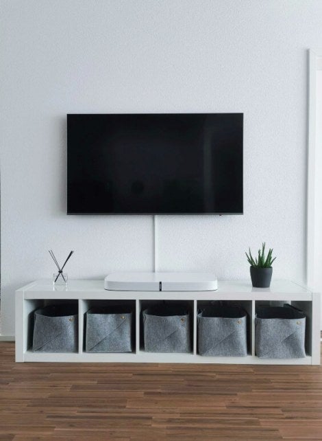 flatscreen tv against a white wall in a home
