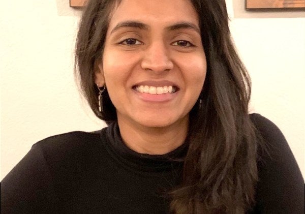 woman in black sweater, medium close-up