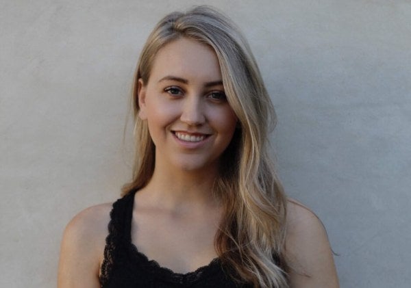 Samantha James, black shirt, plain backdrop