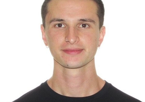 young man, dark-hair buzzcut, black shirt, medium close-up