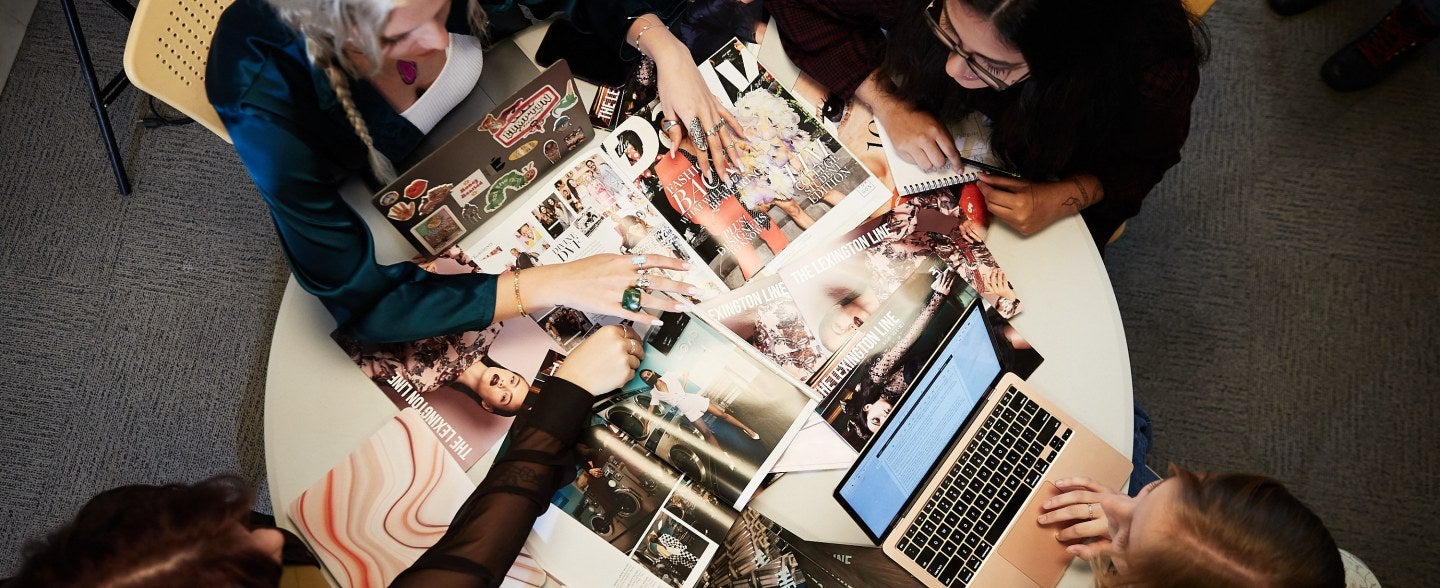 lexington line planning meeting, students sitting around table with magazine pages