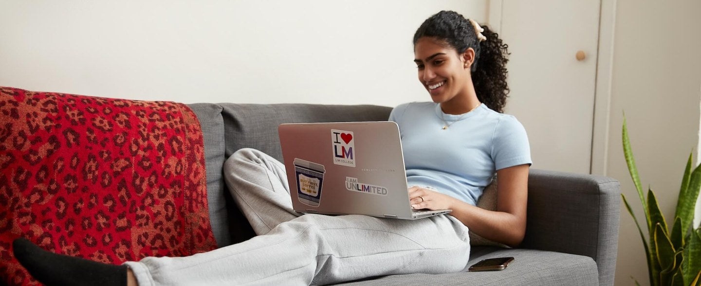 Woman smiling while working on laptop