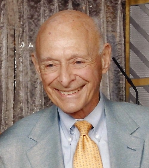 man in suit with yellow tie