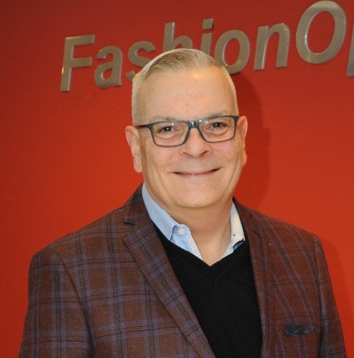 photo of a man wearing glasses, smiling