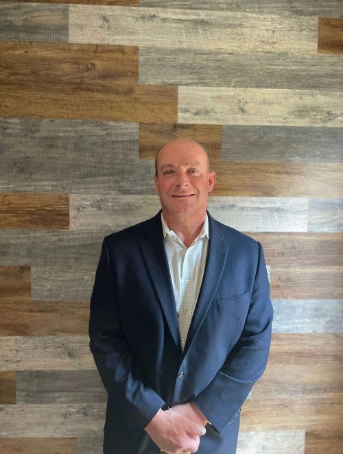 photo of a man in front of tile background