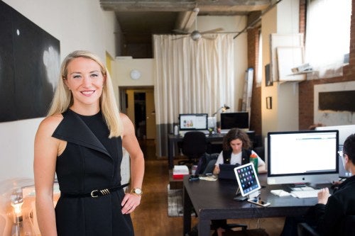 woman in black dress standing in an office