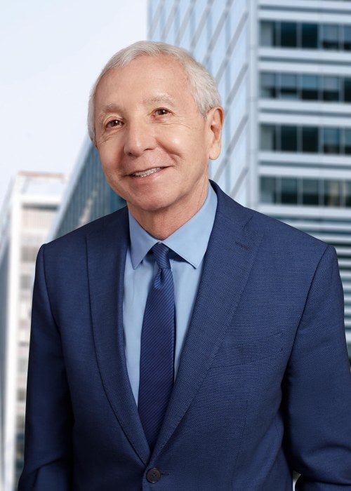 man blue suit in front of skyline