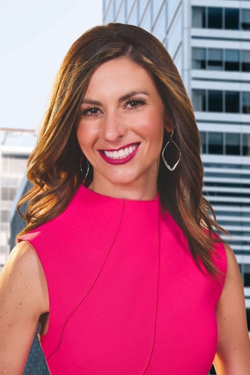 woman in pink shirt smiling at camera