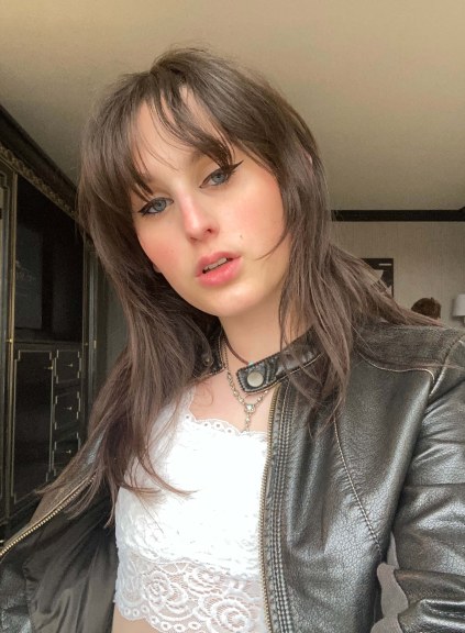 woman with brown hair in leather jacket, medium closeup