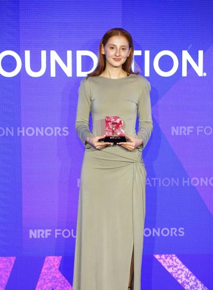 Megan Marr holding NRF Grand Prize award