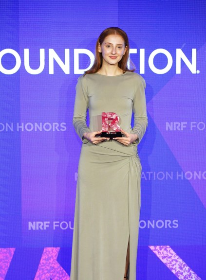 Megan Marr holding NRF Grand Prize award