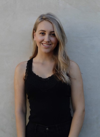 Samantha James, black shirt, plain backdrop