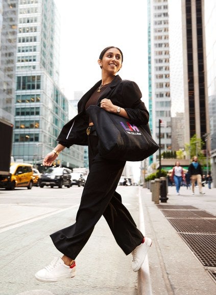 woman with LIM tote bag crossing street