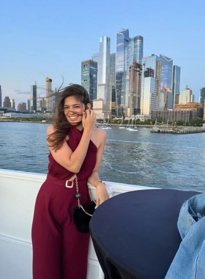 Aishwarya with water and city skyline in background