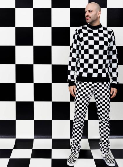 Man wearing checkerboard print infront of checkerboard background