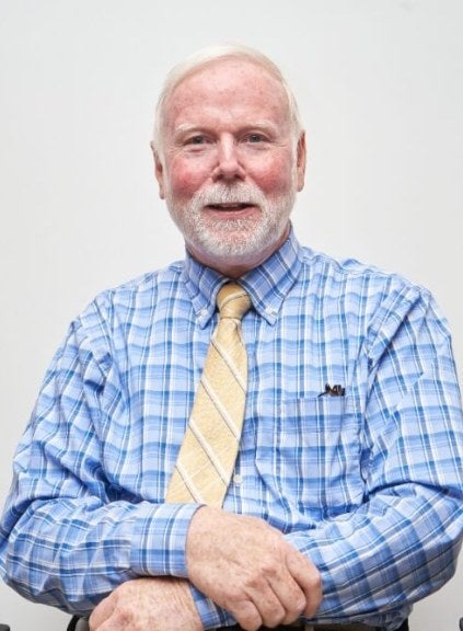 man in a blue shirt with a yellow tie