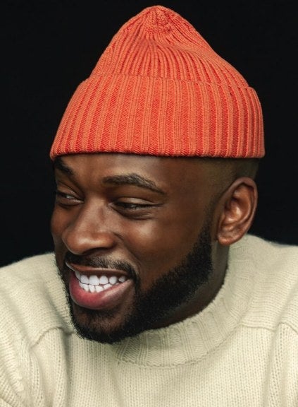 Brandon Smithwrick in sweater and winter hat, black background