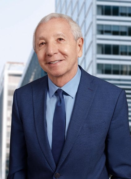 man blue suit in front of skyline