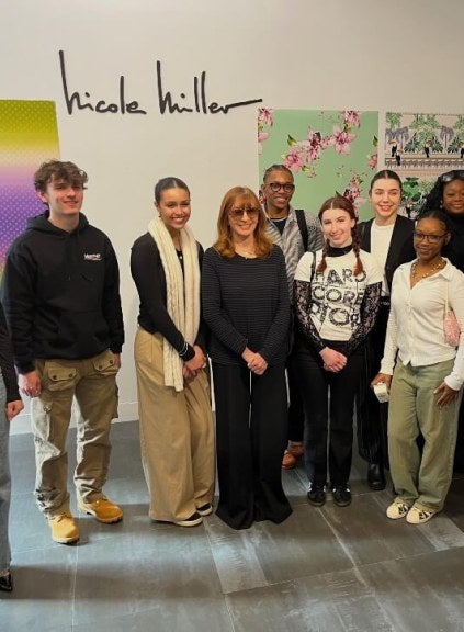 Nicole Miller with students in showroom