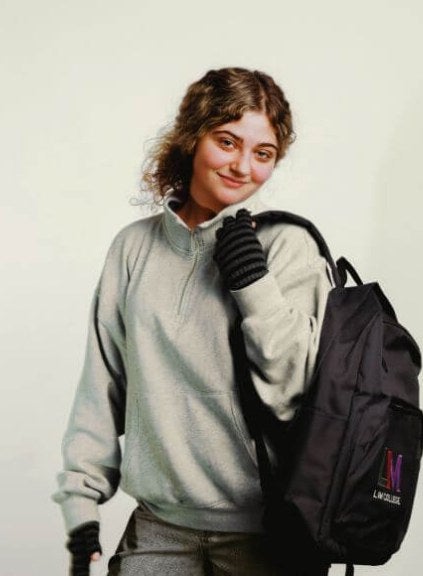 young woman, blond hair, LIM backpack, solid background