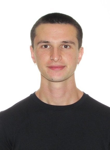 young man, dark-hair buzzcut, black shirt, medium close-up
