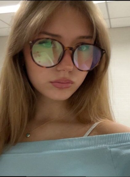 young woman, long blonde hair, glasses, closeup