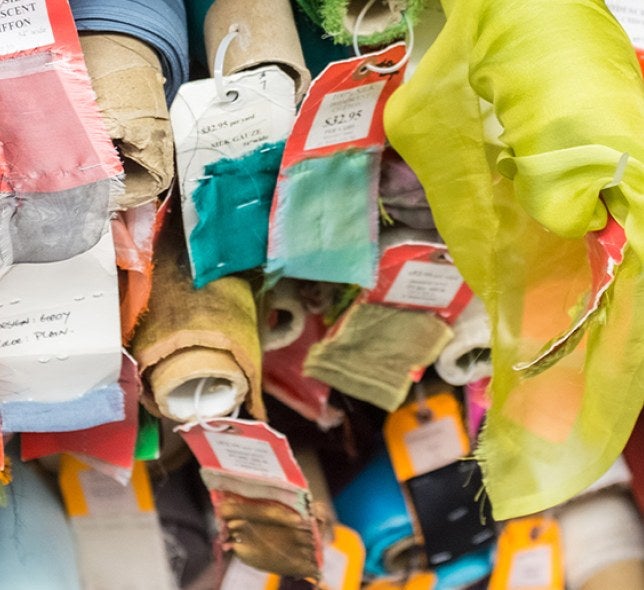 Stacked rolls of colorful fabric.