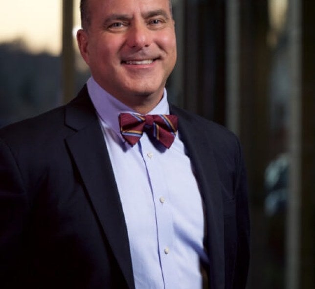 Dr. Fran Felser, medium angle, in front of building windows